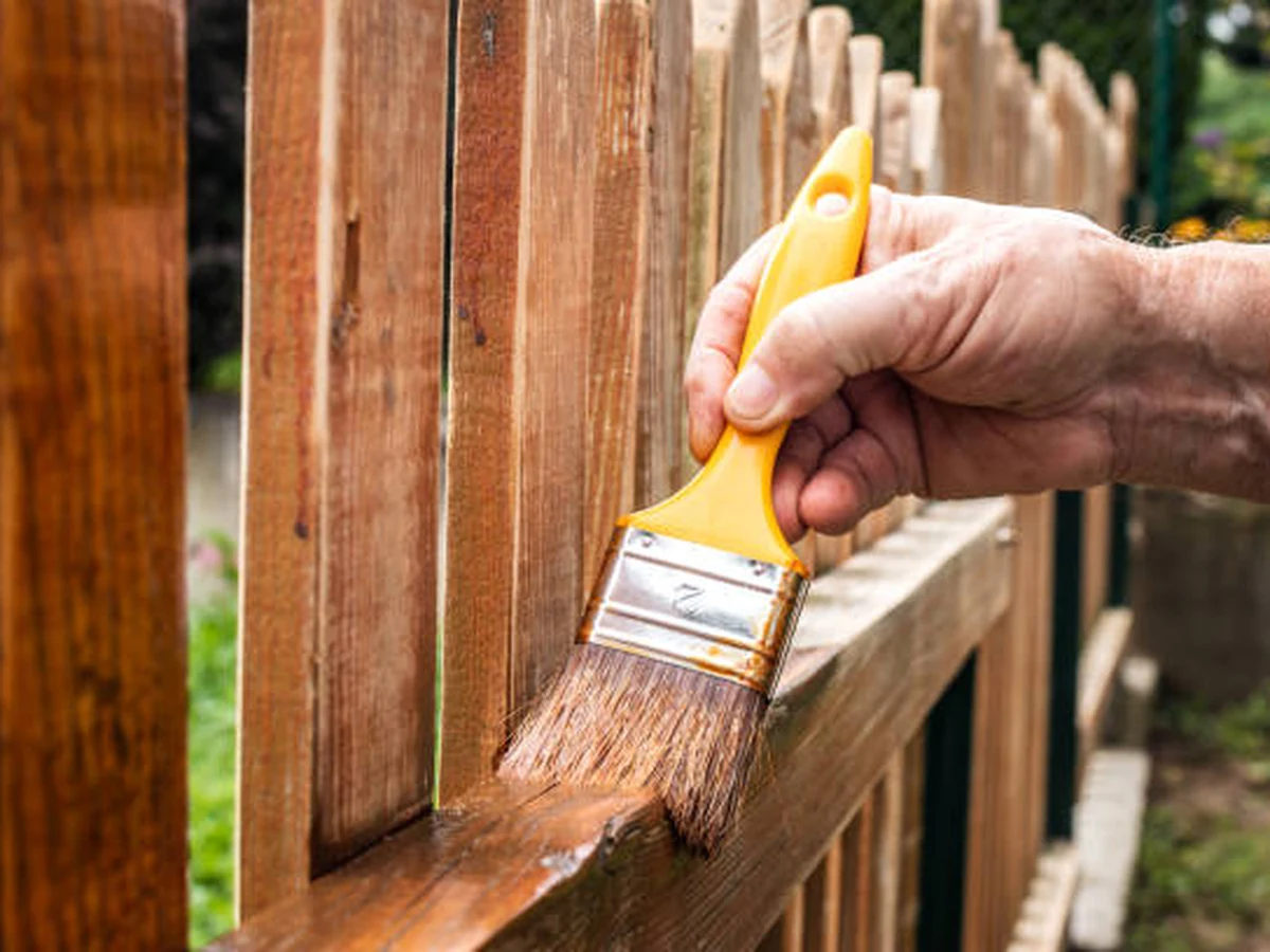 Fence Painting Hand Brush Applying by Plymouth Painters in Plymouth